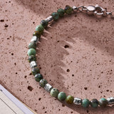 African Turquoise bracelet with 925 sterling silver nuggets styled on a textured stone surface