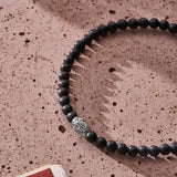 Matte Black Onyx elastic bracelet with engraved sterling silver centre element styled in a Brunati Como setting
