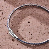 Blue and off-white braided organic cotton bracelet with 925 sterling silver clasp styled on the wrist