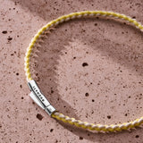 Yellow and off-white braided organic cotton bracelet with 925 sterling silver clasp styled on the wrist