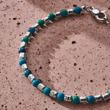 Natural Chrysocolla bracelet with 925 sterling silver nuggets styled on a textured surface
