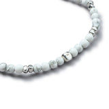 Detail of natural Howlite elastic bracelet with smooth 925 sterling silver pebble elements and BC centre cube