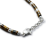 Detail of Japanese Tiger Eye-style stone paste discs with organic 925 sterling silver nugget elements