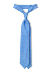 Light blue silk tie tied in a classic threefold knot.
