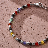 Multicolor natural stone bracelet with 925 sterling silver nuggets styled on a textured surface
