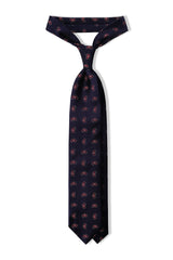 Navy paisley silk jacquard tie tied in a classic threefold knot