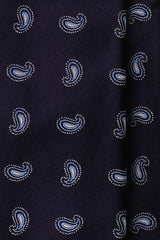 Close-up of woven light blue paisley pattern on navy silk jacquard tie.