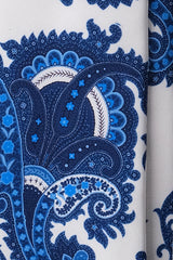 Close-up of paisley pattern on light blue Italian printed silk tie.