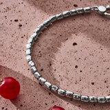 Handmade 925 sterling silver Nugget Bracelet styled on a textured surface