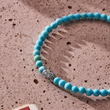 Natural Turquoise elastic bracelet with engraved sterling silver centre element styled in a Brunati Como setting