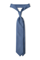Light blue, navy and pink butterfly chains printed silk tie, tied in a clean knot.