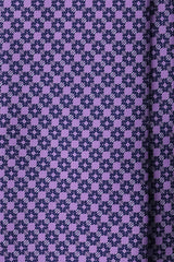 Close-up of the printed silk fabric with lilac, petrol and light blue butterfly chain motifs.