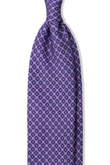 Lilac, petrol and light blue butterfly chains printed silk tie, shown from the front.