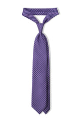 Lilac, petrol and light blue butterfly chains printed silk tie, tied in a clean knot.