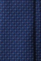 Close-up of the printed silk fabric with navy, blue and white butterfly chain motifs.