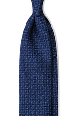 Navy, blue and white butterfly chains printed silk tie, shown from the front.