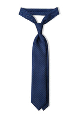 Navy, blue and white butterfly chains printed silk tie, tied in a clean knot.