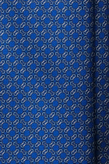 Close-up of the printed silk fabric with royal blue, light blue and white butterfly chain motifs.