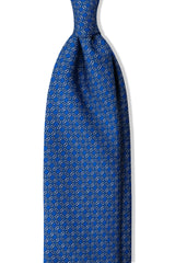 Royal blue, light blue and white butterfly chains printed silk tie, shown from the front.
