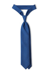 Royal blue, light blue and white butterfly chains printed silk tie, tied in a clean knot.