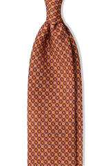 Salmon, orange and light blue butterfly chains printed silk tie, shown from the front.