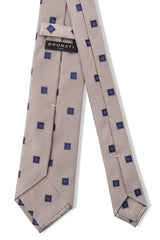 Back view of the beige and royal blue geometric square silk jacquard tie.