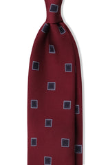 Bordeaux and navy geometric square silk jacquard tie, shown from the front.
