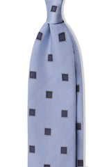 Light blue and navy geometric square silk jacquard tie, shown from the front.