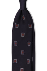 Navy and red geometric square silk jacquard tie, shown from the front.