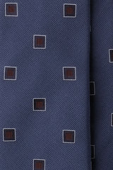 Close-up of petrol silk jacquard fabric with burgundy geometric square motifs.