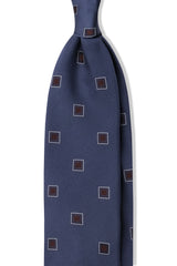 Petrol and burgundy geometric square silk jacquard tie, shown from the front.