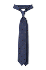 Petrol and burgundy geometric square silk jacquard tie, tied in a clean knot.