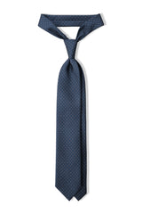Petrol horsebit printed silk tie, tied in a clean knot.