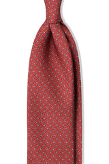 Red horsebit printed silk tie, shown from the front.
