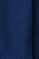 Close-up of the textured royal blue silk shantung fabric.