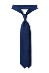 Royal blue plain silk shantung tie, tied in a knot.