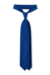 Azure blue and white polka dot grenadine shantung silk tie, tied in a knot.