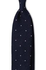 Navy and white polka dot grenadine shantung silk tie, shown from the front.