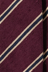 Close-up of burgundy, beige and navy striped silk shantung fabric texture