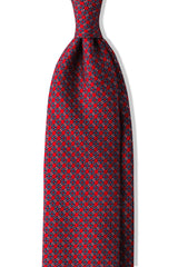 Red, light blue and white butterfly chains printed silk tie, shown from the front.