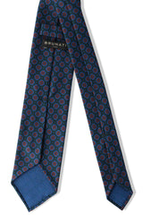 Back view of the forest, blue and orange floral Ancient Madder silk tie with hand-rolled edges.