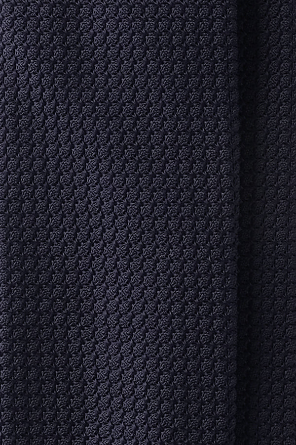 Detailed view of the Grenadine fabric pattern (Garza Grossa) used in the handmade tie navy