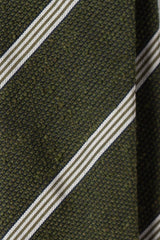 Close-up of the textured green and white grenadine shantung silk fabric.