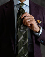Model styling the green and white grenadine shantung silk tie with tailored clothing.
