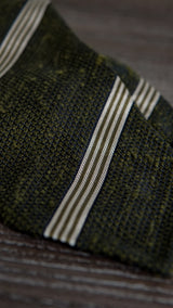 Green and white grenadine shantung silk tie shown in a styled mood image.