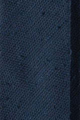 Close-up of the textured navy grenadine shantung silk fabric.