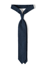 Navy plain grenadine shantung silk tie, tied in a knot.