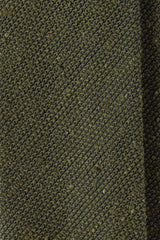 Close-up of the textured olive grenadine shantung silk fabric.
