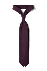 Purple plain grenadine shantung silk tie, tied in a knot.