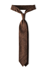 Mustard plain silk shantung tie, tied in a knot.